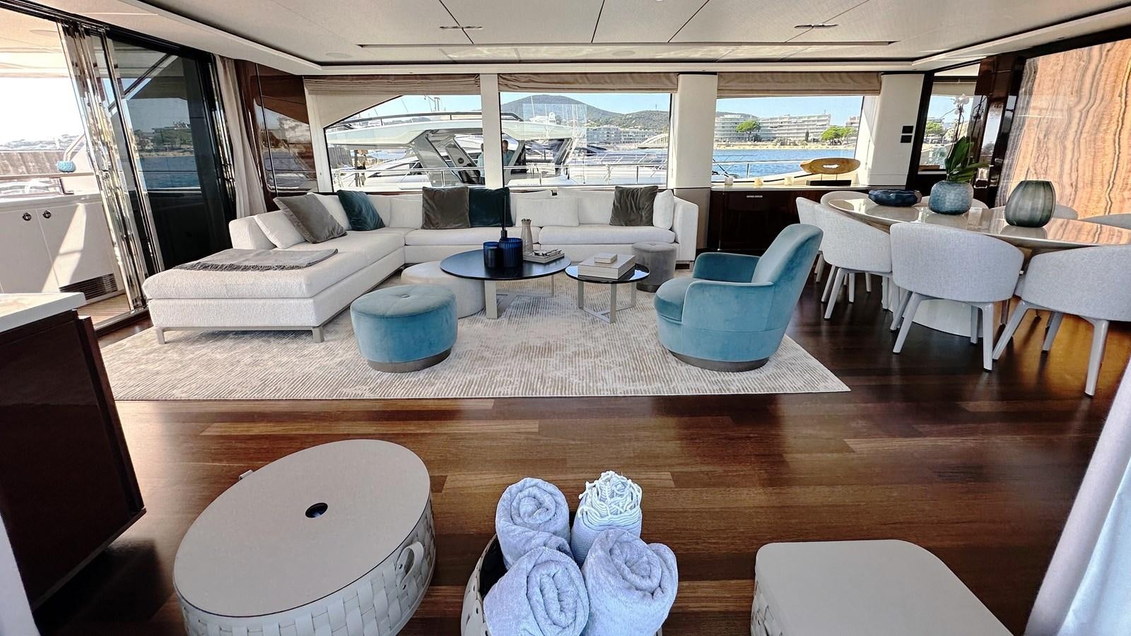 a room with a table chairs and a couch aboard GHOST Yacht for Sale