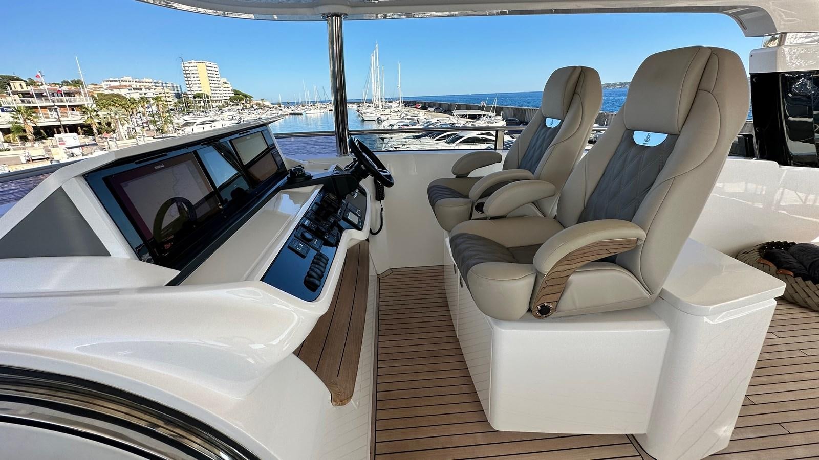 a boat with seats and a steering wheel on a deck aboard GHOST Yacht for Sale