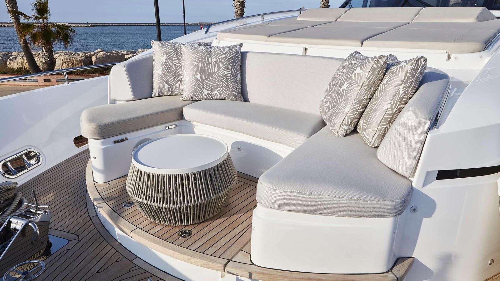 a white couch with a white pillow on it aboard GHOST Yacht for Sale