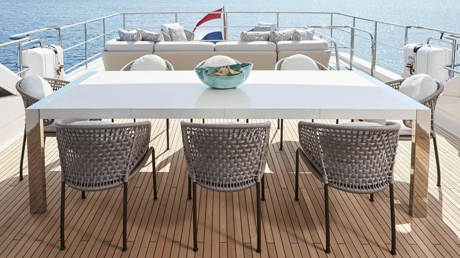 a table with chairs around it aboard GHOST Yacht for Sale