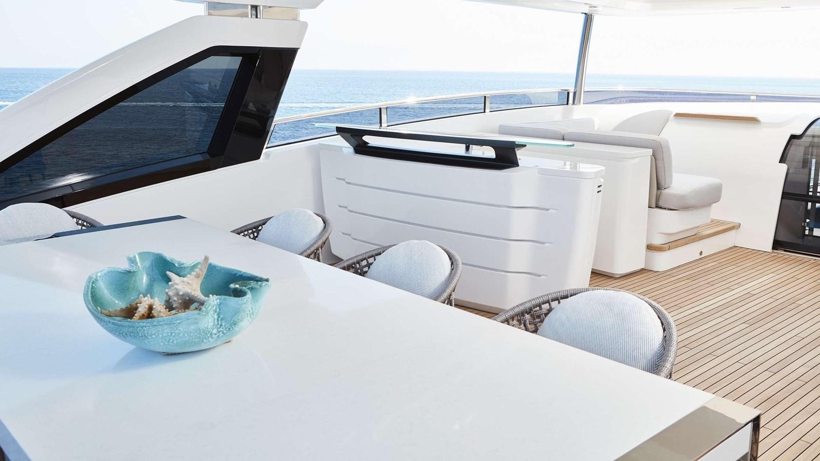 a white table with a bowl of food and a bowl of ice cream on it aboard GHOST Yacht for Sale