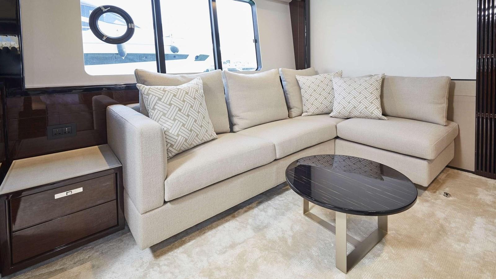 a couch and a table in a room aboard GHOST Yacht for Sale