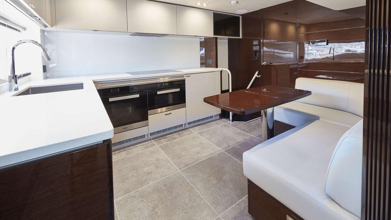 a kitchen with a countertop sink and a stove aboard GHOST Yacht for Sale