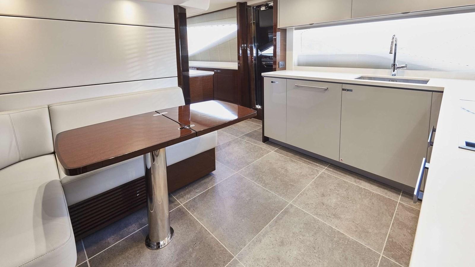 a kitchen with a table and a bench aboard GHOST Yacht for Sale