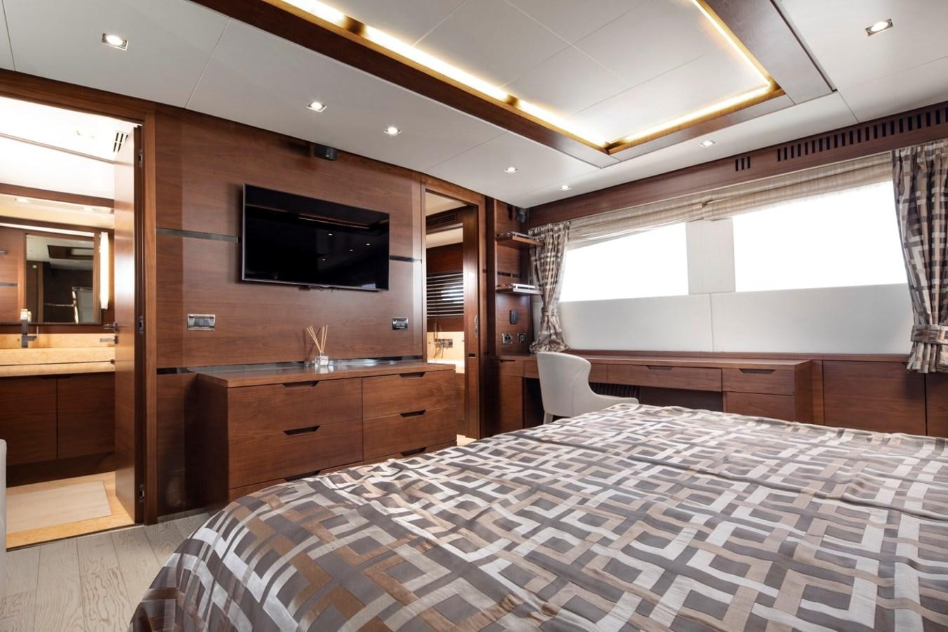 a bedroom with a bed and a tv aboard NIMIR Yacht for Sale
