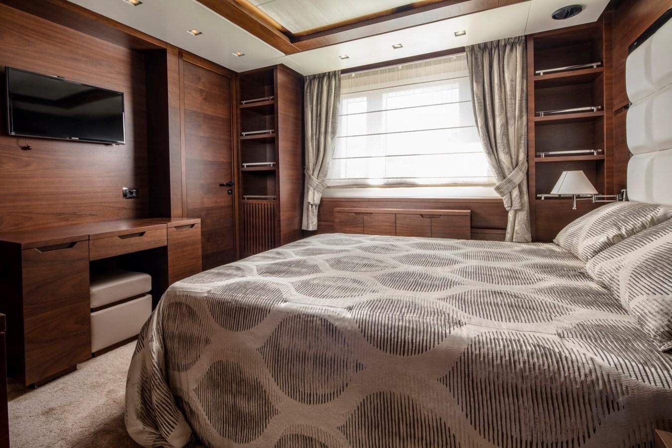 a bedroom with a bed and a television aboard NIMIR Yacht for Sale