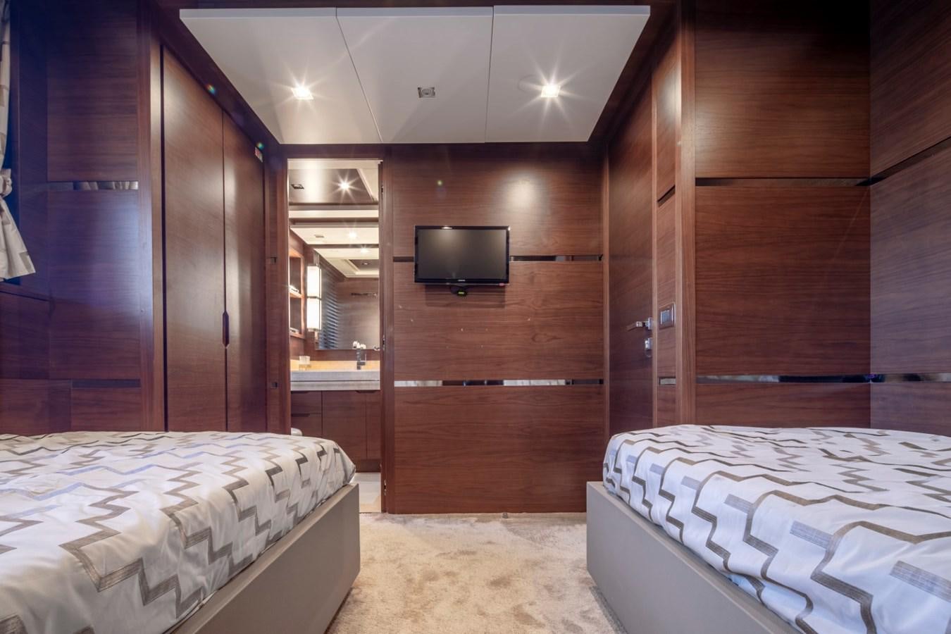 a room with a bed and a television aboard NIMIR Yacht for Sale