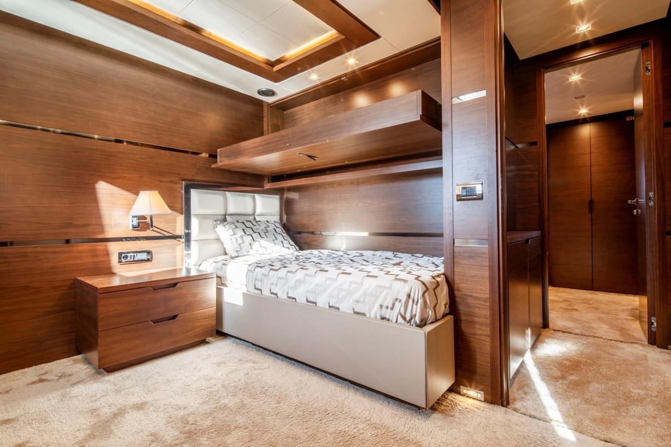 a bedroom with a bed and a desk aboard NIMIR Yacht for Sale