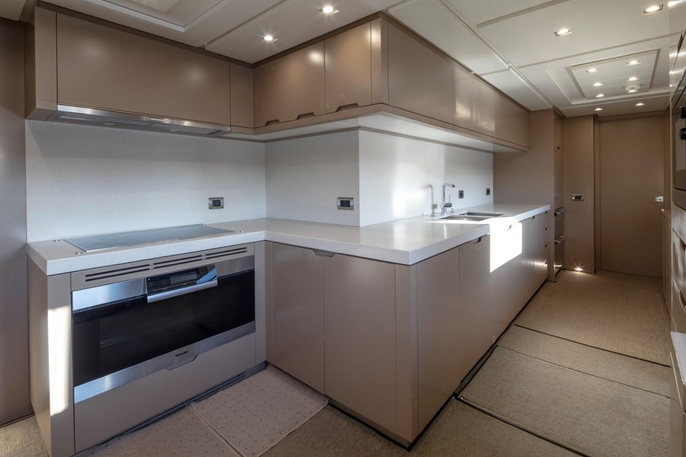 a kitchen with white cabinets aboard NIMIR Yacht for Sale