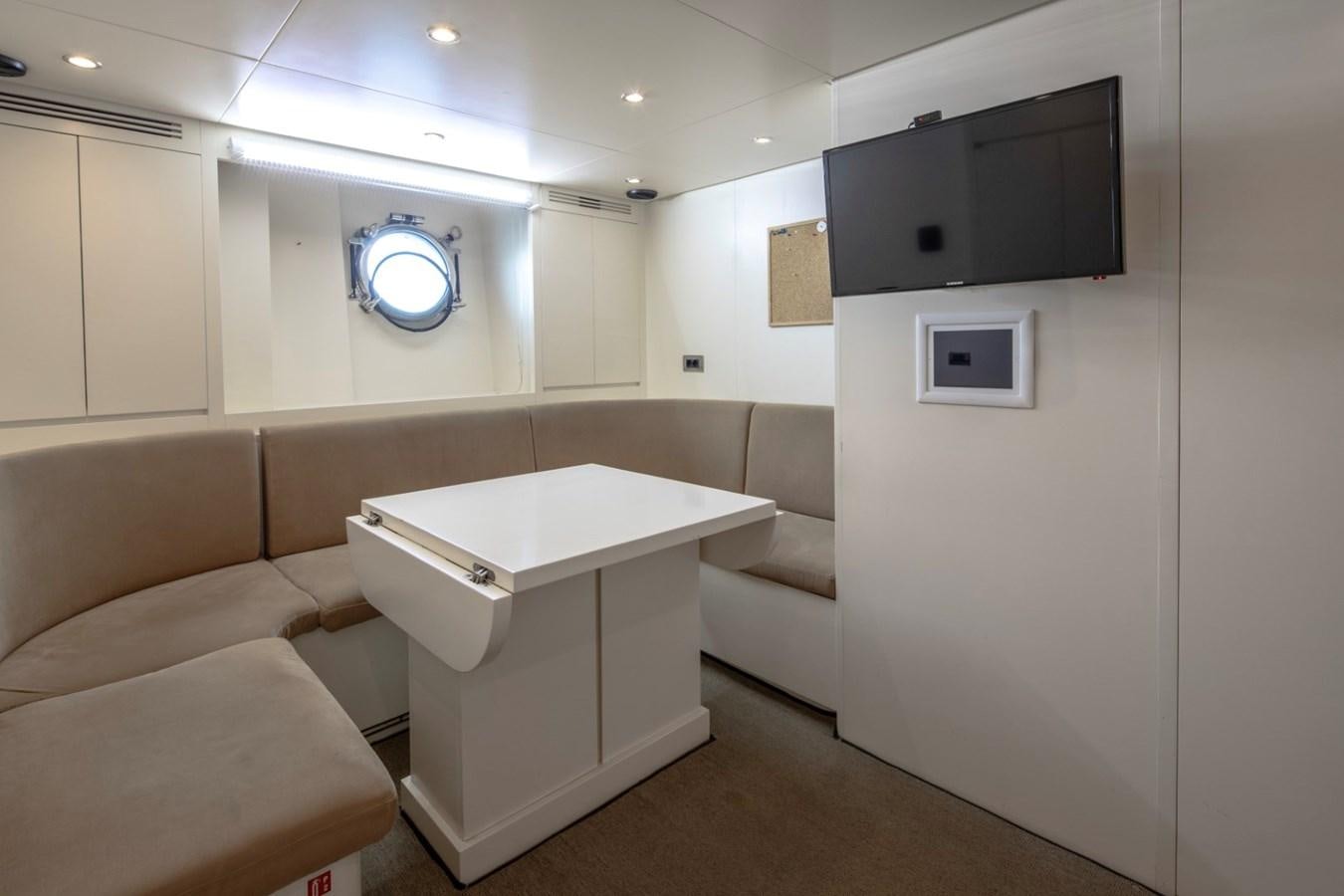 a room with a couch and a television aboard NIMIR Yacht for Sale