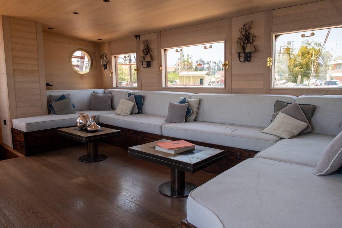 a living room with a couch and a coffee table aboard CASSIOPEIA Yacht for Sale