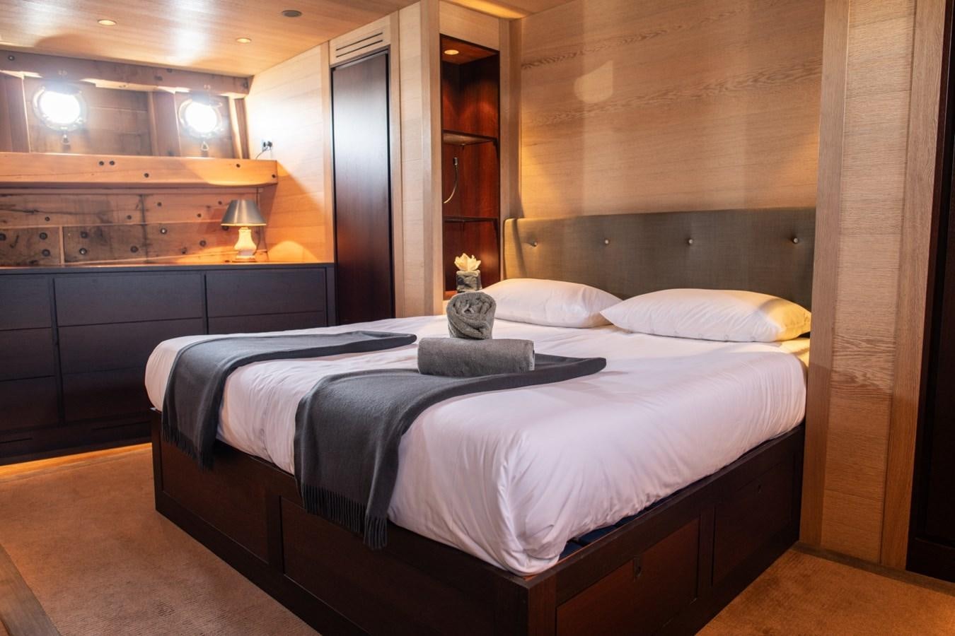 a bed with white sheets aboard CASSIOPEIA Yacht for Sale
