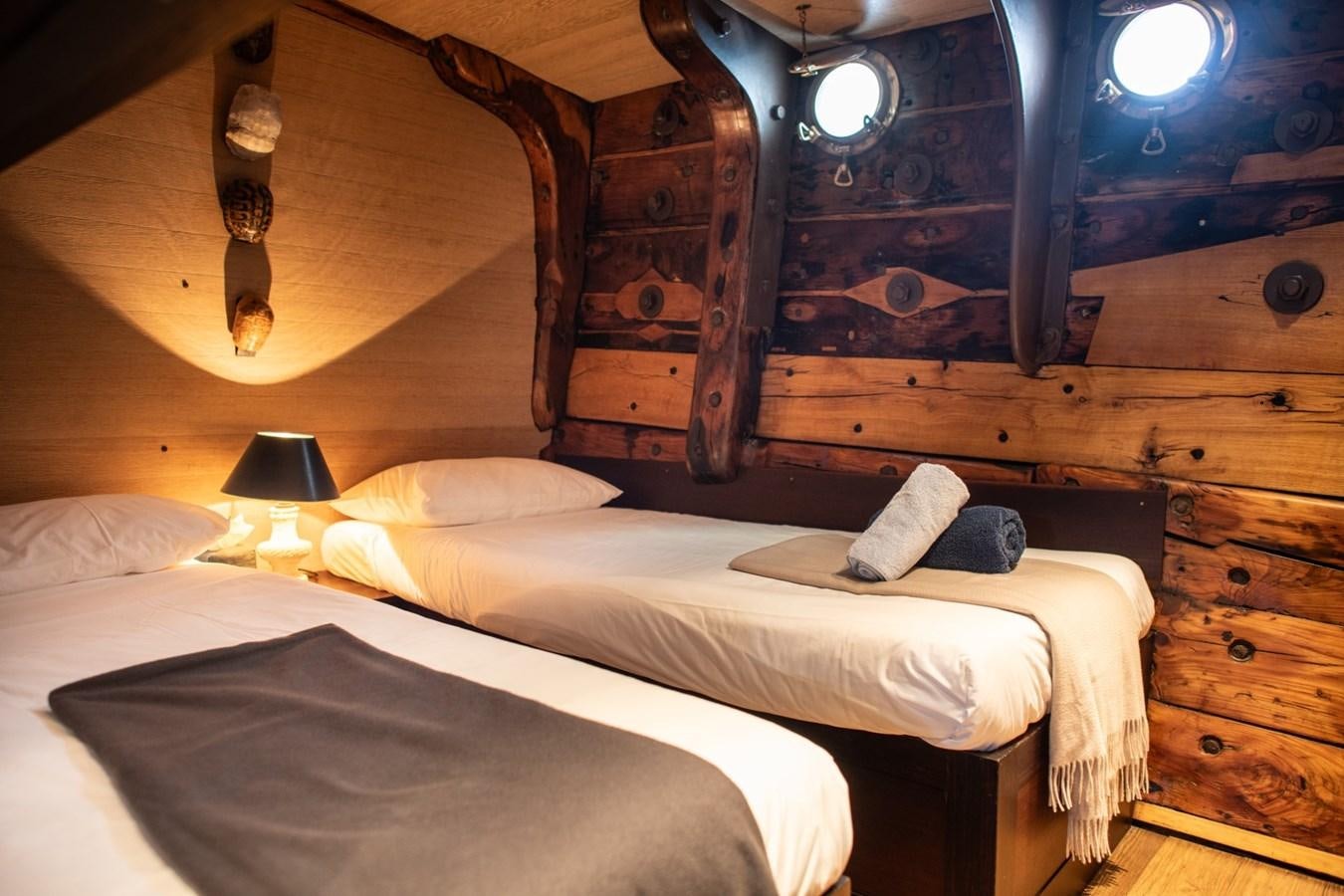a couple of beds in a room aboard CASSIOPEIA Yacht for Sale