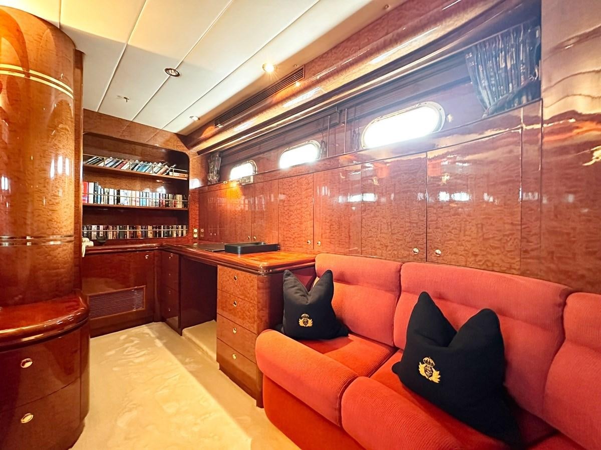 a living room with a red couch aboard MALARPRINSESSAN Yacht for Sale