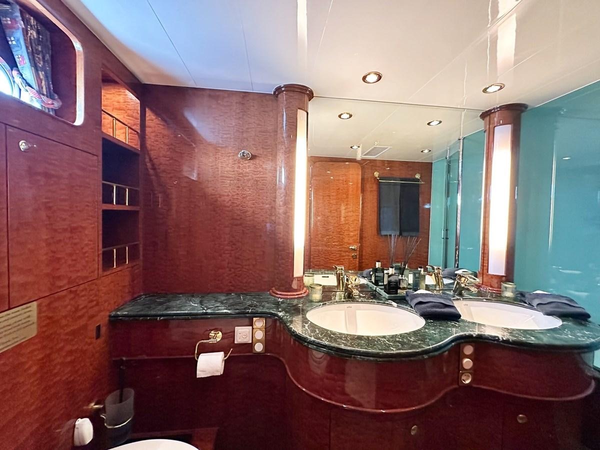 a bathroom with a countertop sink and a large mirror aboard MALARPRINSESSAN Yacht for Sale