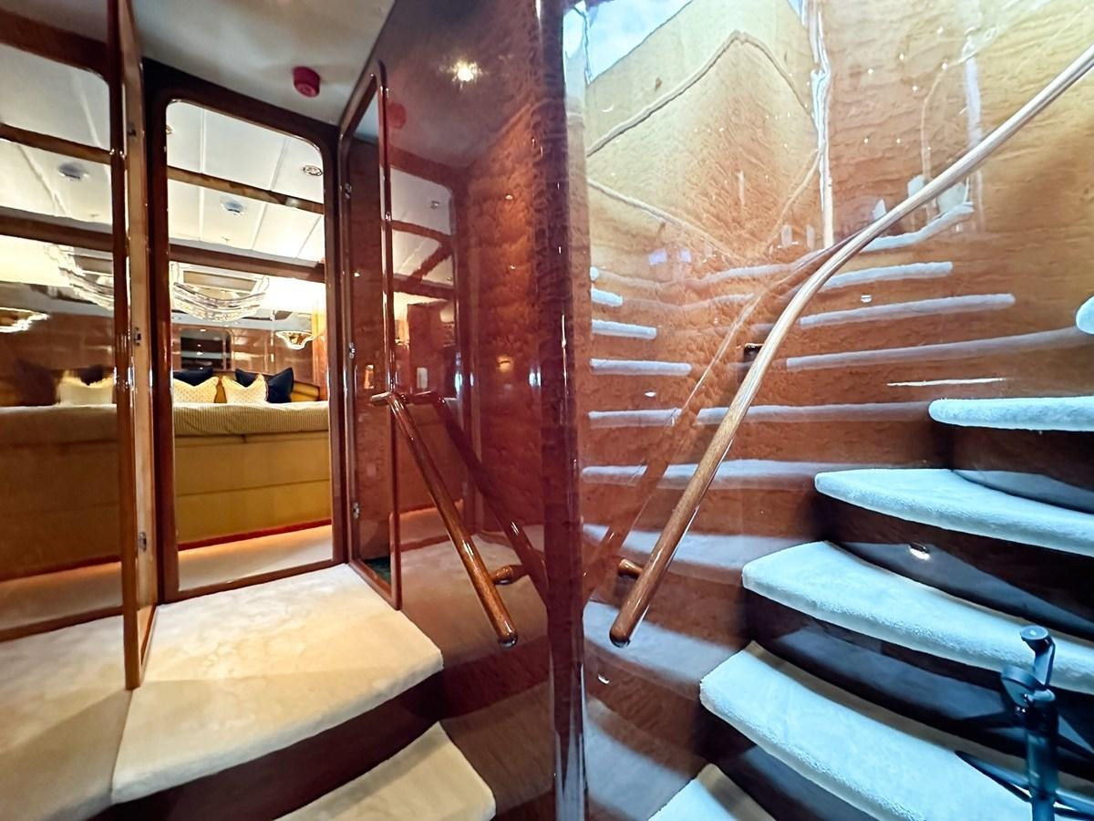a room with wooden walls and a glass door aboard MALARPRINSESSAN Yacht for Sale