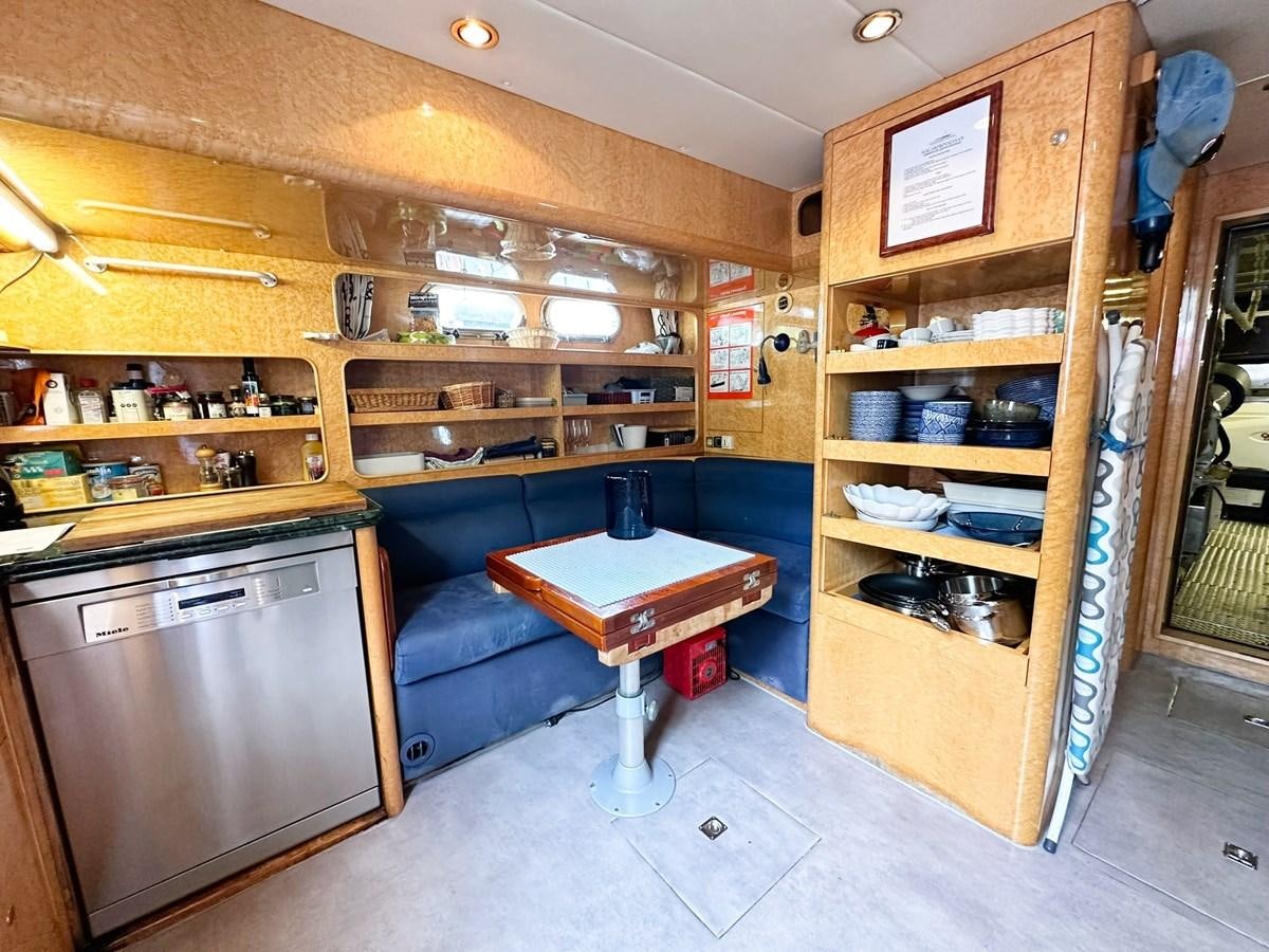 a kitchen with a couch and a table aboard MALARPRINSESSAN Yacht for Sale