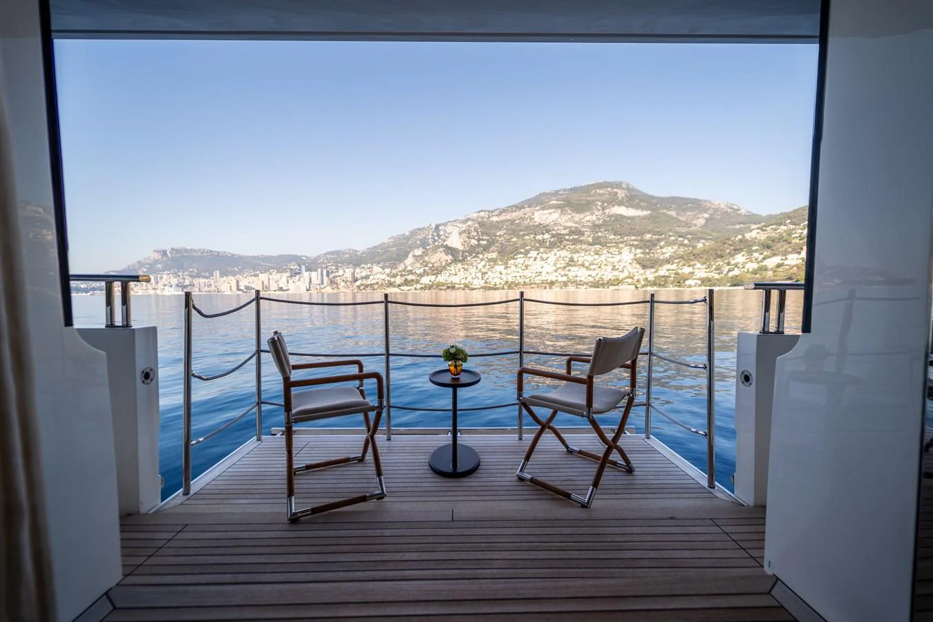 a balcony with a table and chairs aboard BLUES Yacht for Sale