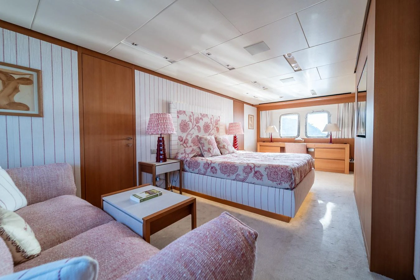 a bedroom with a bed and a table aboard BLUES Yacht for Sale