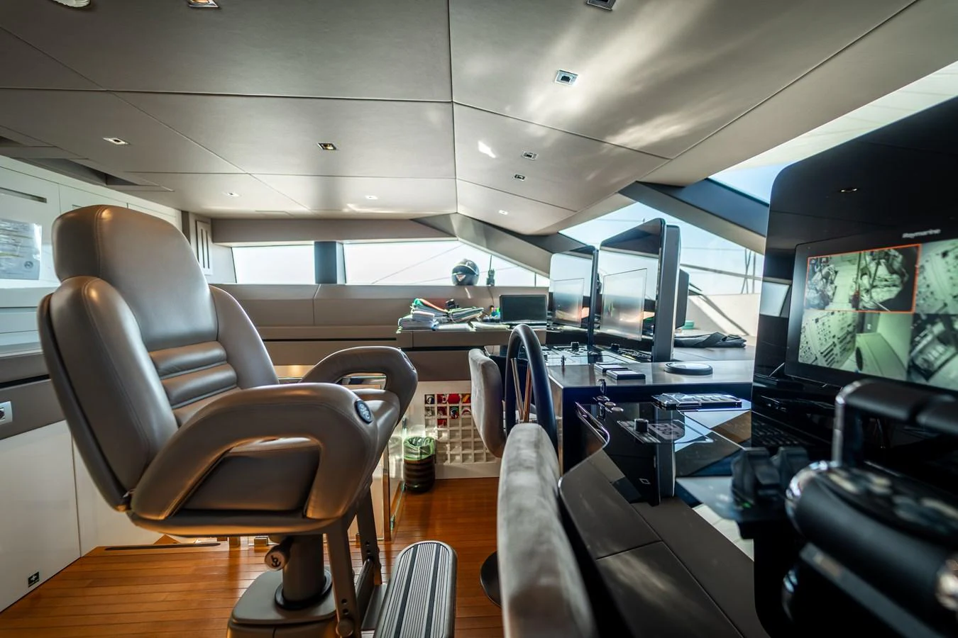 a room with chairs and computers aboard BLUES Yacht for Sale