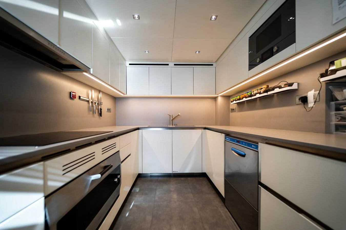 a kitchen with white cabinets aboard BLUES Yacht for Sale