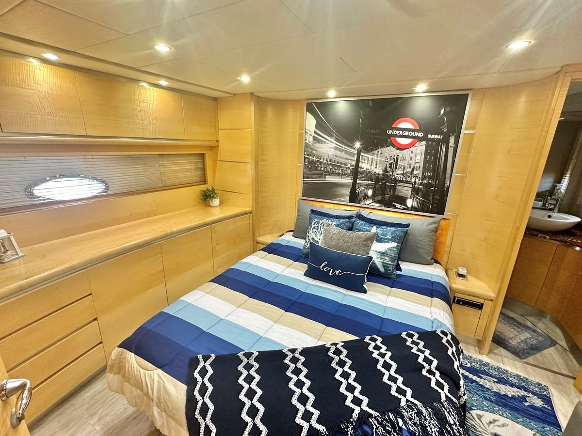 a room with a bed and a tv aboard NOTORIUS Yacht for Sale