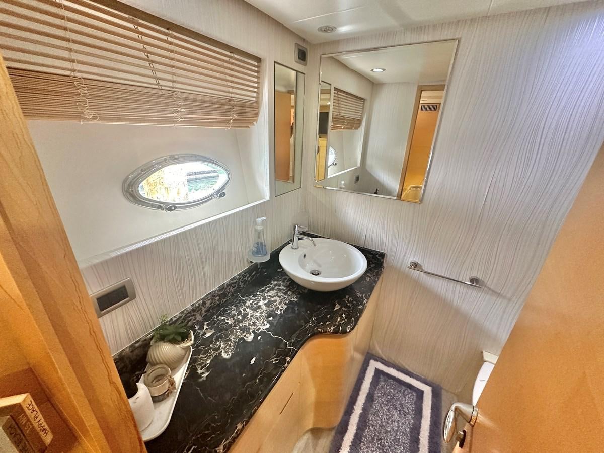 a bathroom with a sink and a mirror aboard NOTORIUS Yacht for Sale