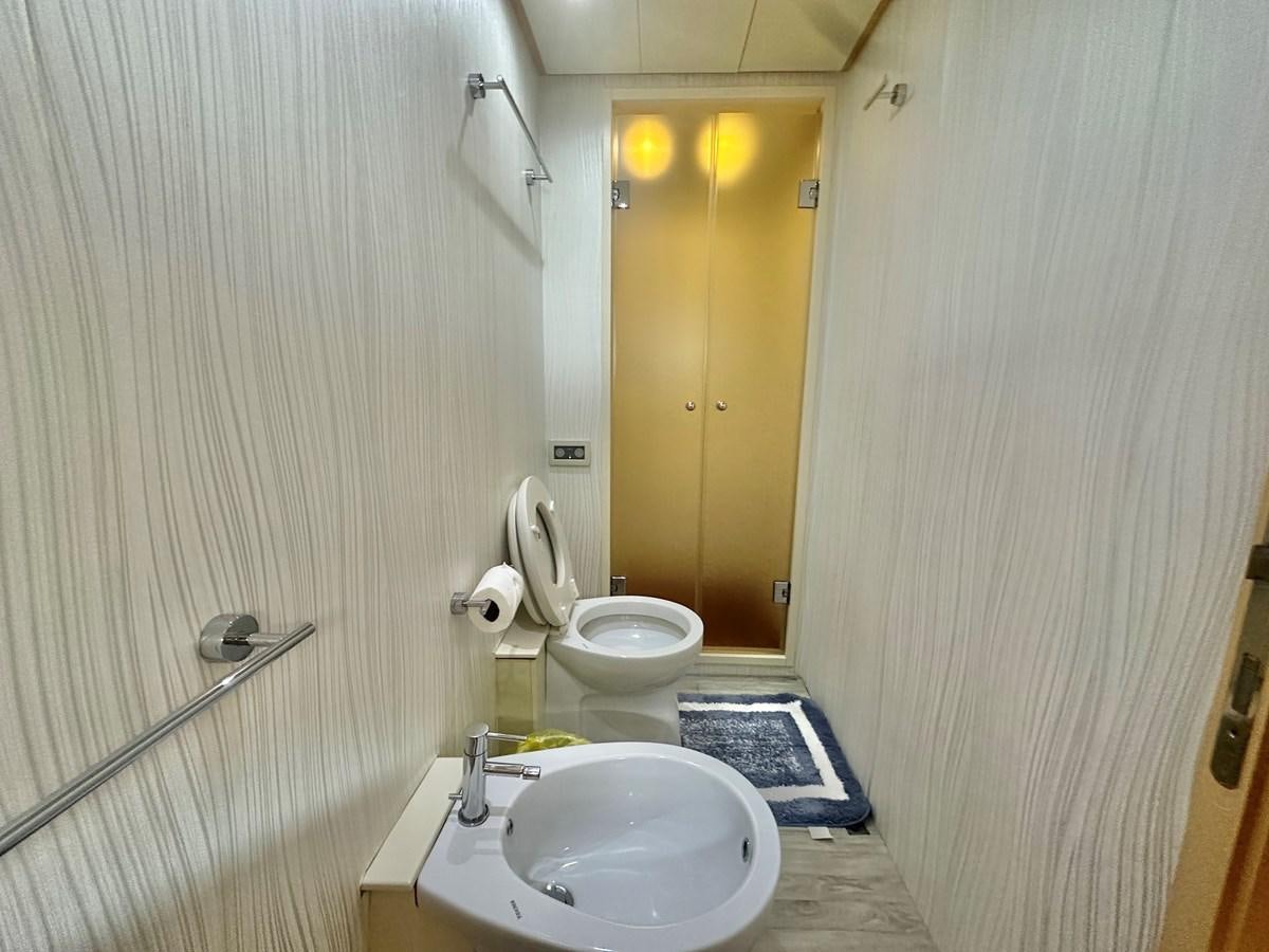 a bathroom with a toilet and sink aboard NOTORIUS Yacht for Sale