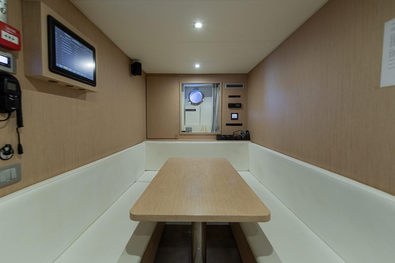 a room with a table and tv aboard SWEET LANE Yacht for Sale