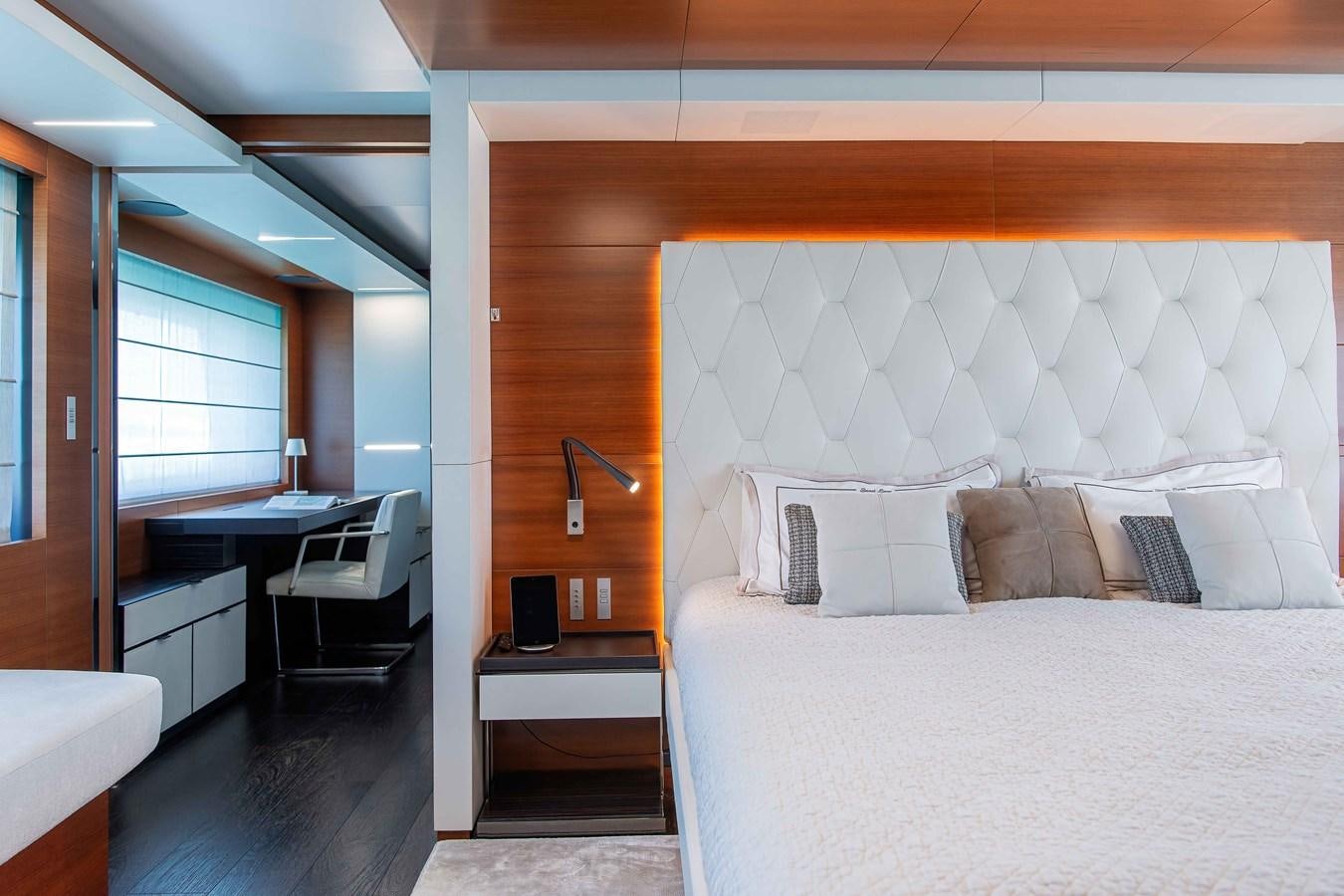 a bedroom with a bed and desk aboard SWEET LANE Yacht for Sale