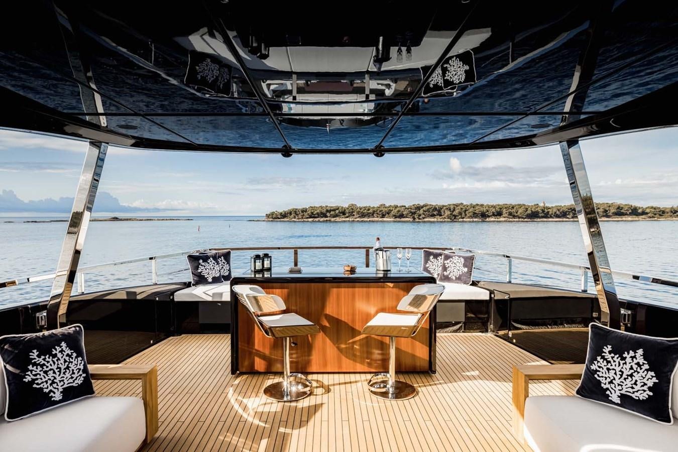 a deck with chairs and a table aboard HULL #02 Yacht for Sale