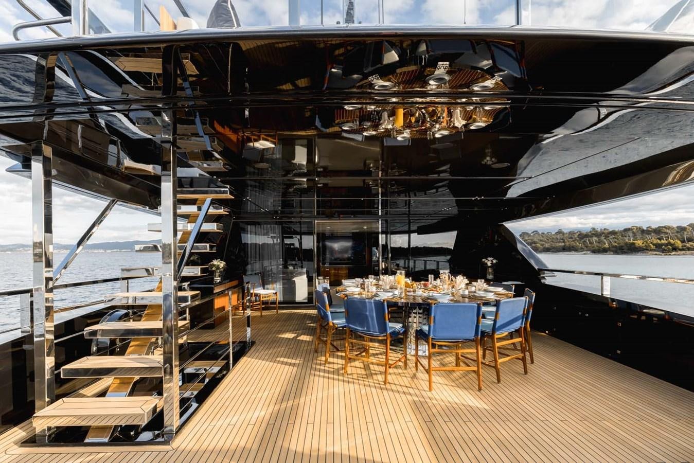 a room with a table and chairs aboard HULL #02 Yacht for Sale