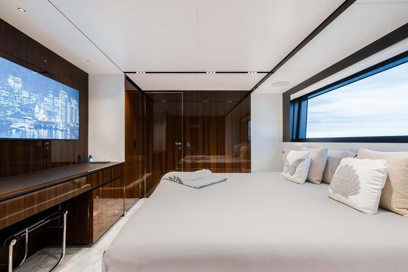 a bed with a white bed spread aboard HULL #02 Yacht for Sale