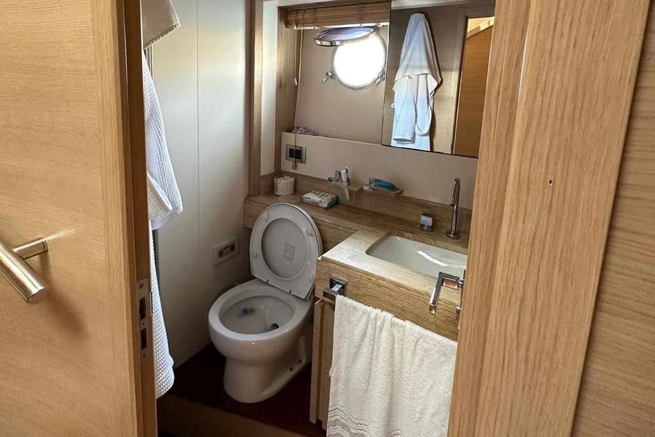 a bathroom with a toilet sink and a mirror aboard AZIMUT 84/12 Yacht for Sale