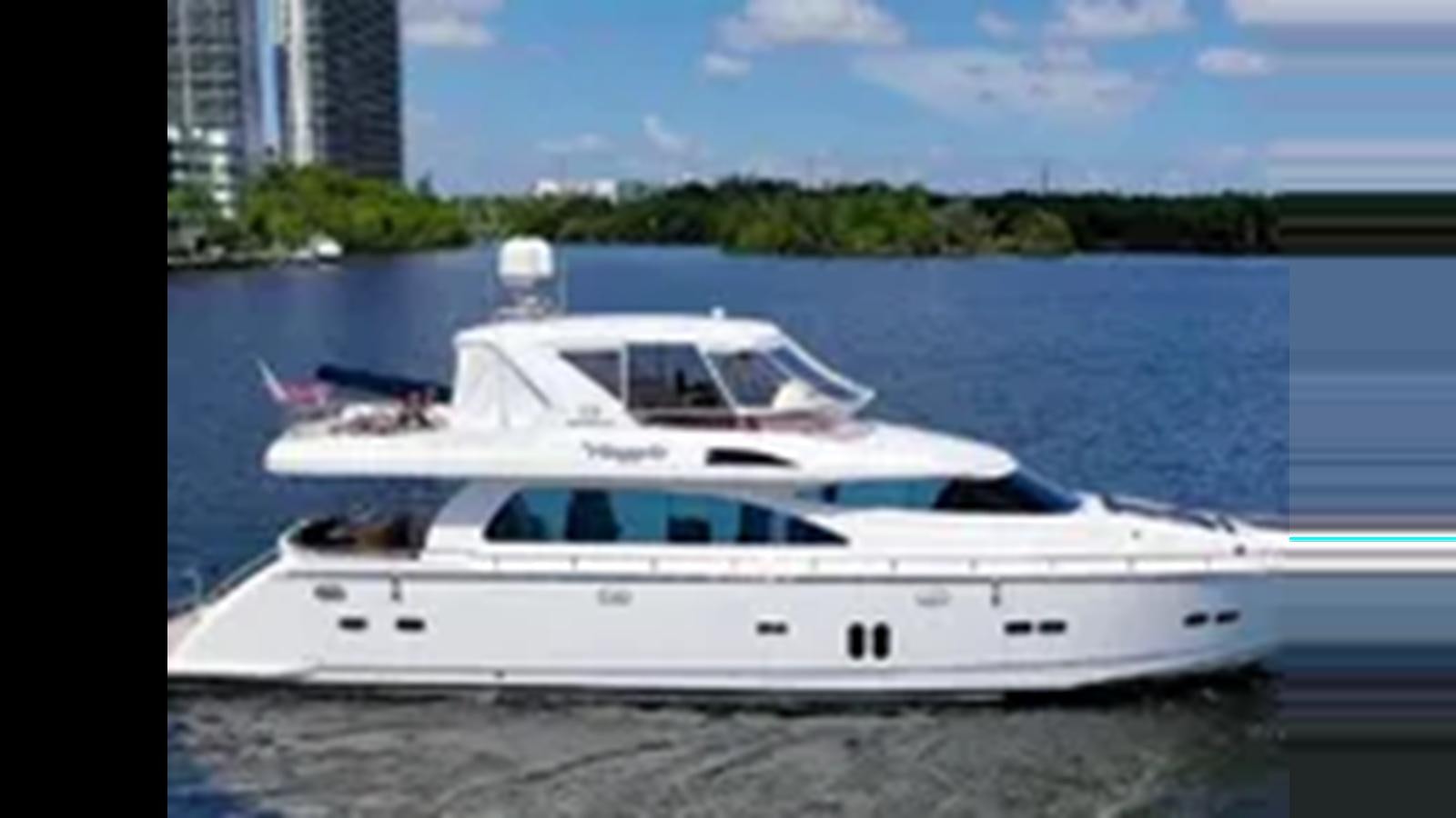 a white yacht on a beach aboard 2009 HORIZON VISION 74 Yacht for Sale