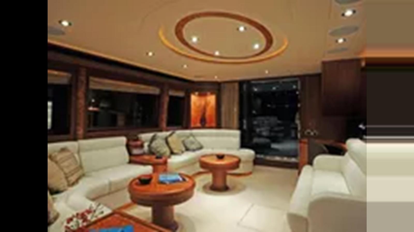 a living room with a fireplace aboard 2009 HORIZON VISION 74 Yacht for Sale
