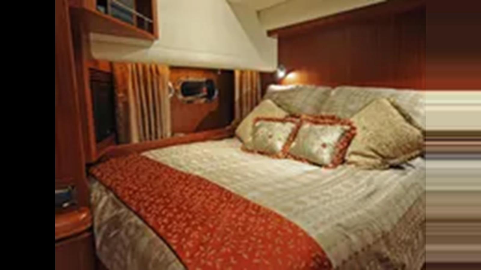 a bed with a white comforter aboard 2009 HORIZON VISION 74 Yacht for Sale