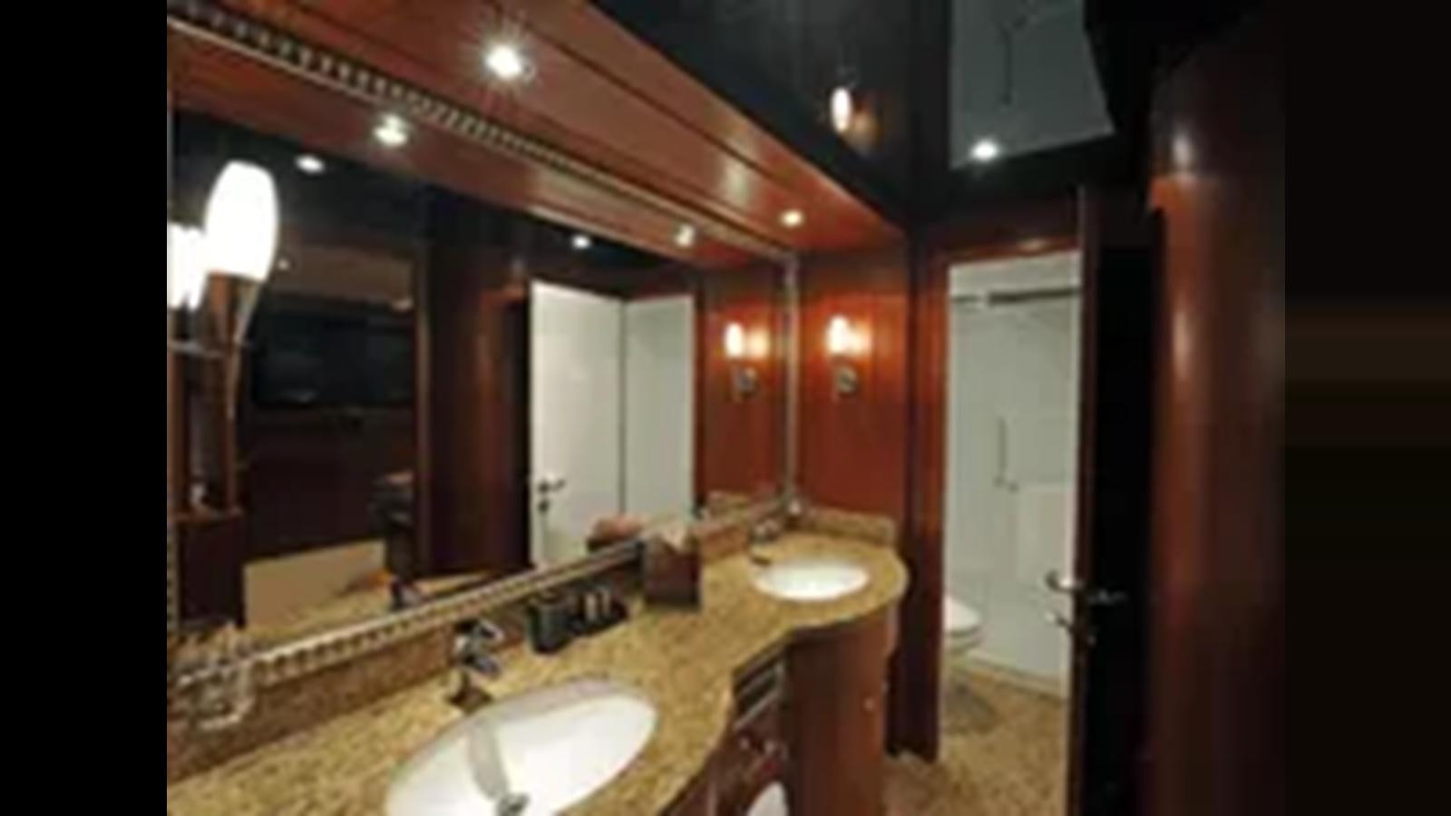 a bathroom with sinks and mirrors aboard 2009 HORIZON VISION 74 Yacht for Sale