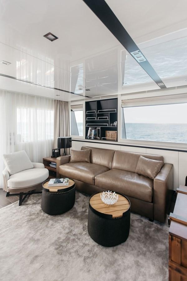 a living room with a couch and a coffee table aboard BERING 76  LEMANJA Yacht for Sale