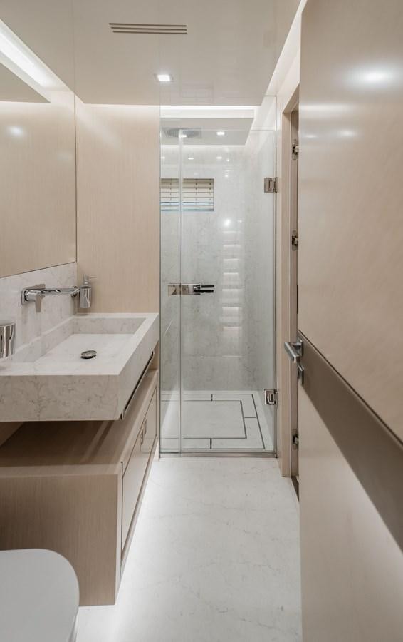 a bathroom with a glass shower aboard BERING 76  LEMANJA Yacht for Sale