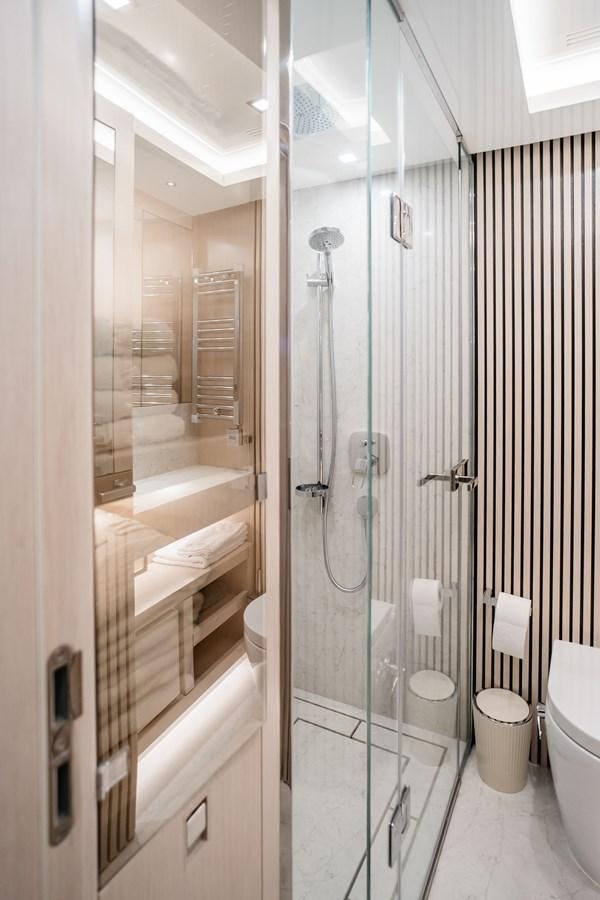 a bathroom with a glass shower aboard BERING 76  LEMANJA Yacht for Sale