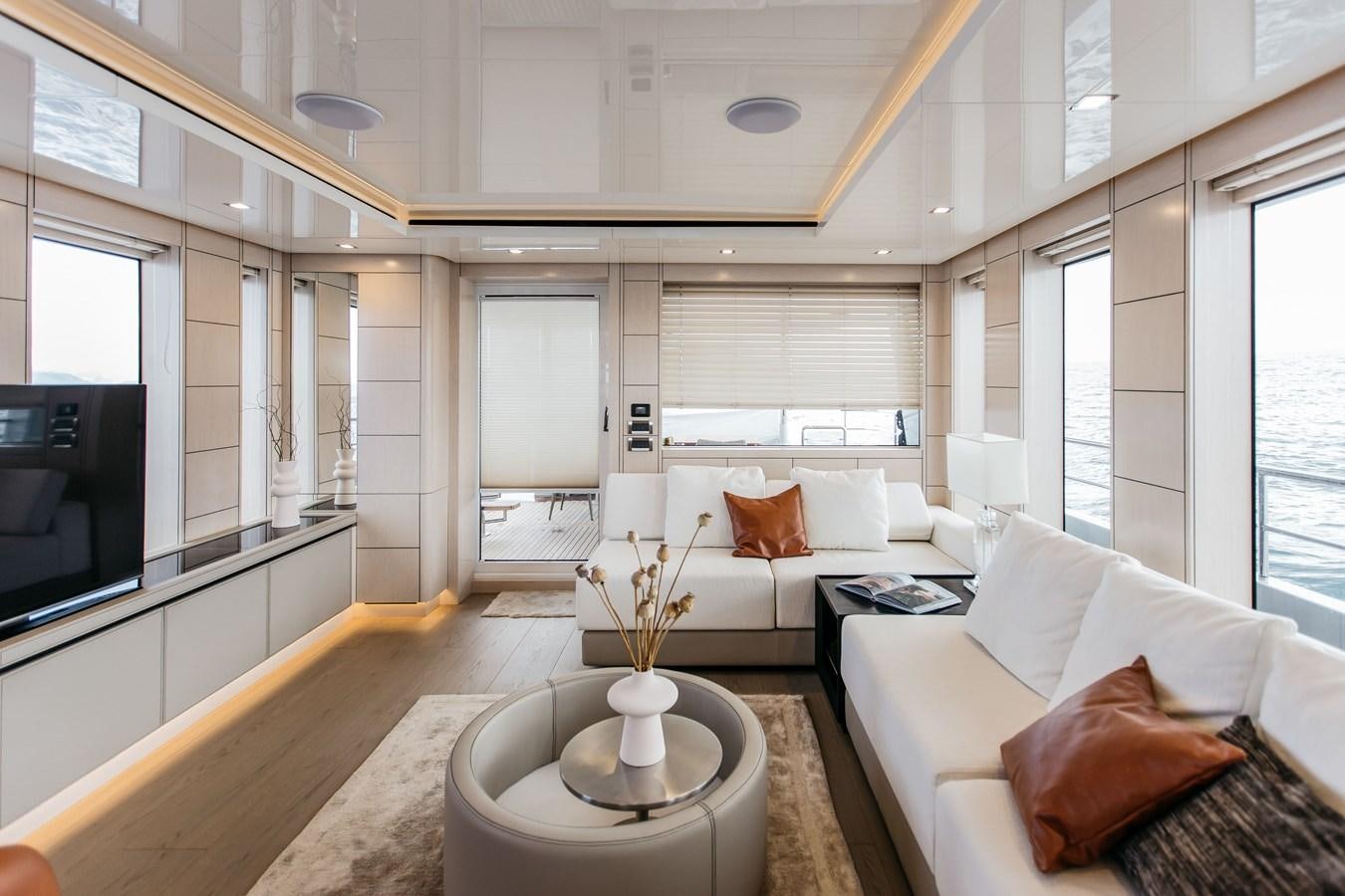 a living room with a large window aboard BERING 76  LEMANJA Yacht for Sale