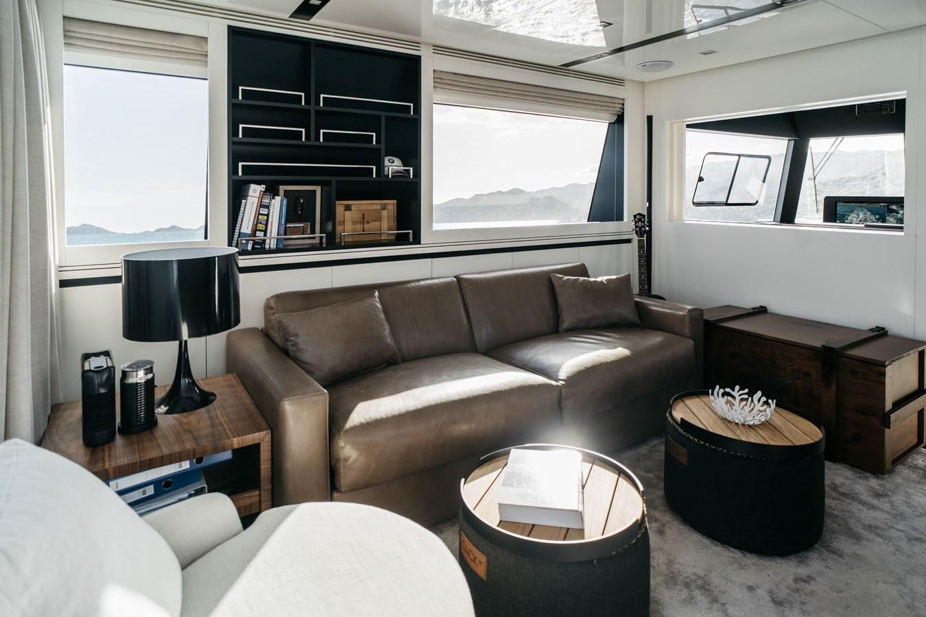 a living room with a leather couch aboard BERING 76  LEMANJA Yacht for Sale
