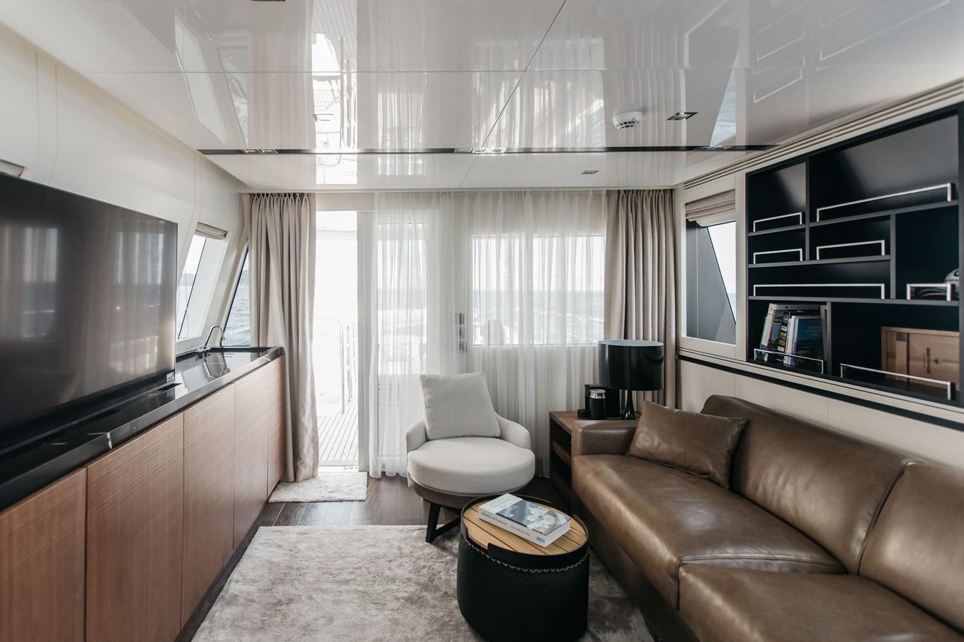 a living room with a couch and a tv aboard BERING 76  LEMANJA Yacht for Sale