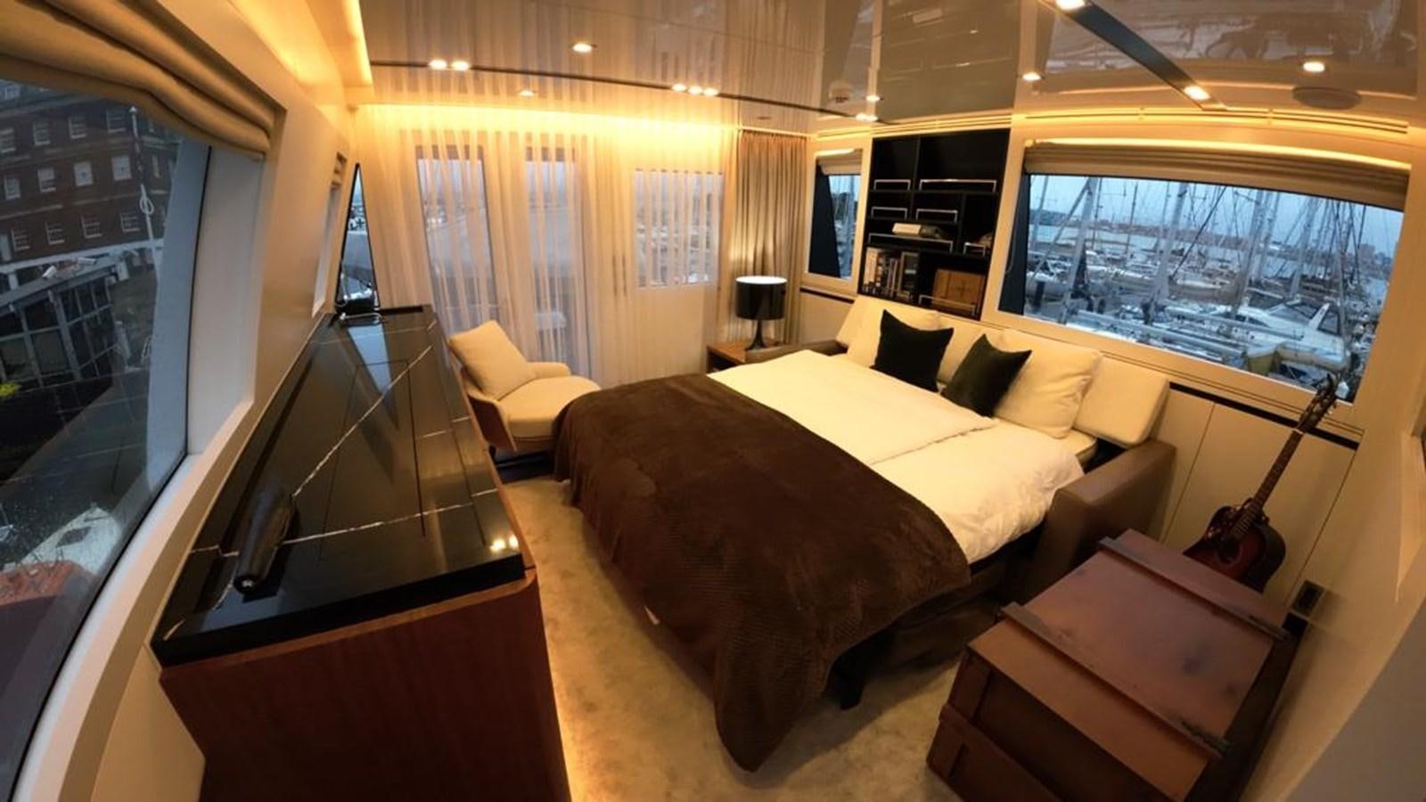 a room with a bed and a desk aboard BERING 76  LEMANJA Yacht for Sale