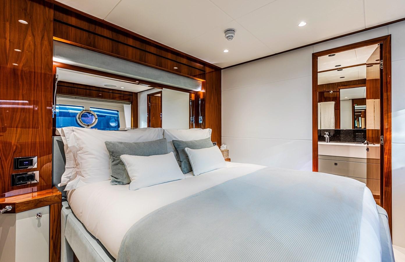 a bed with a white sheet aboard KUDOS Yacht for Sale