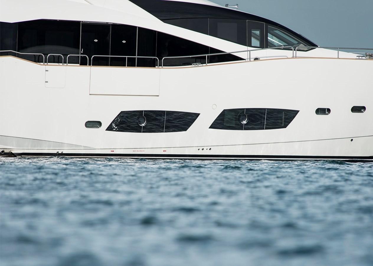 a white yacht in the water aboard KUDOS Yacht for Sale