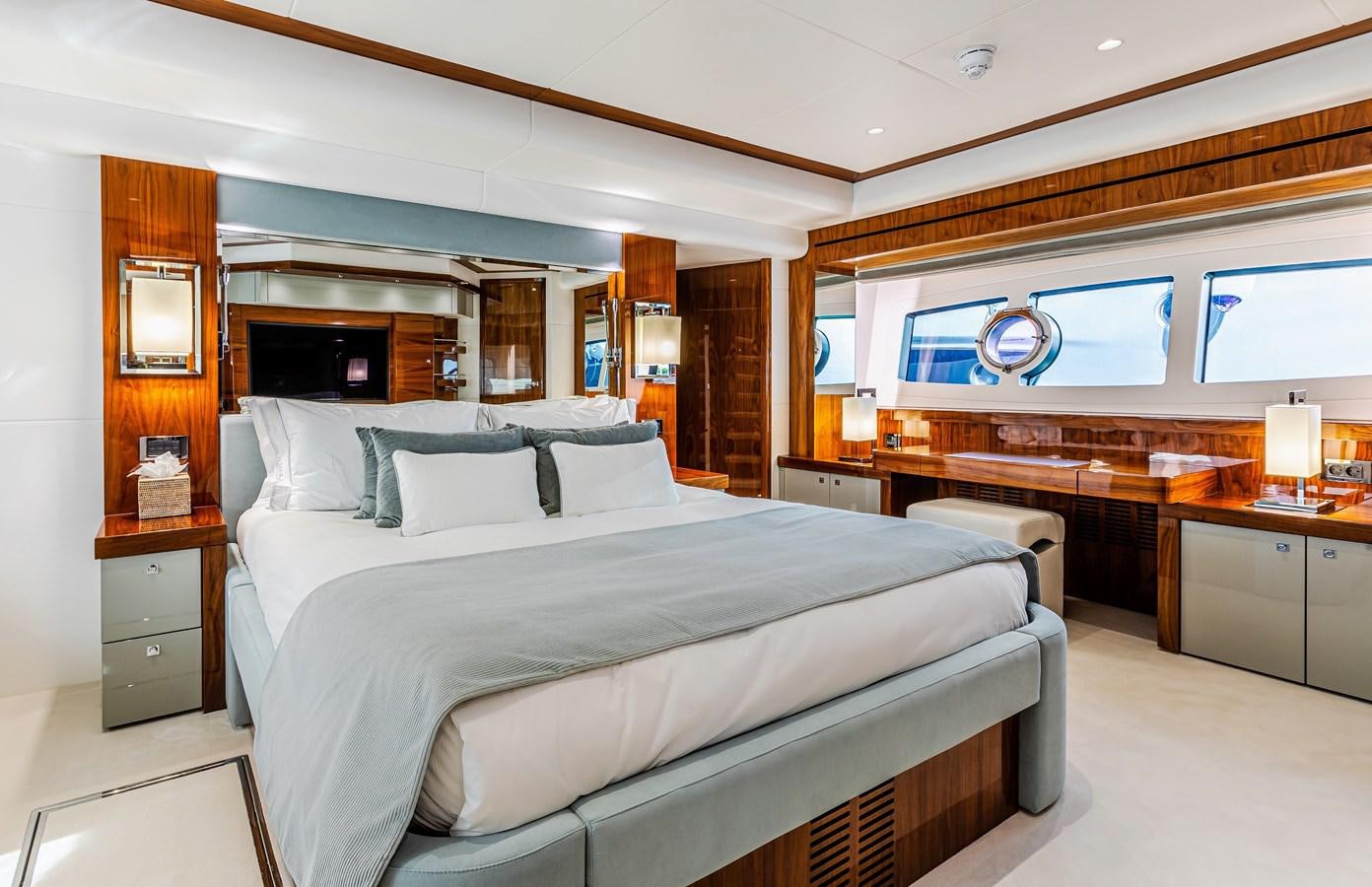 a large bed in a room aboard KUDOS Yacht for Sale