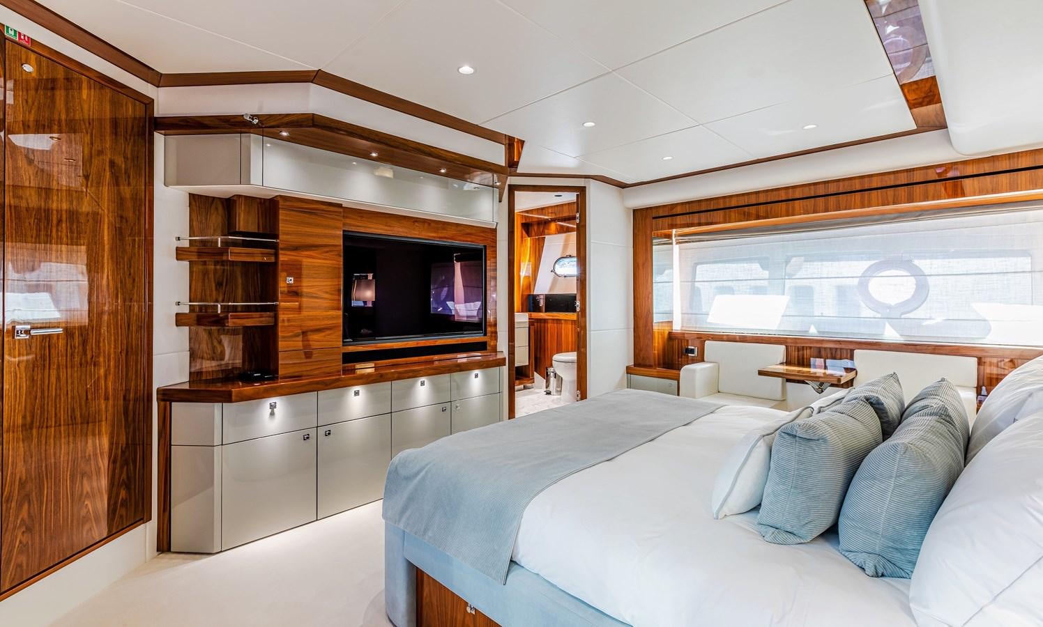 a room with a bed and a tv aboard KUDOS Yacht for Sale