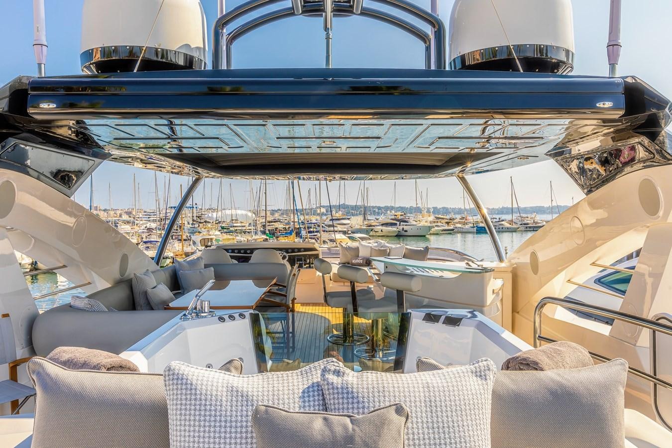 a boat with a deck and chairs aboard KUDOS Yacht for Sale